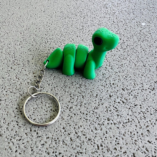 Charming green brontosaurus keychain with a textured body, perfect for adding flair to keys or bags.
