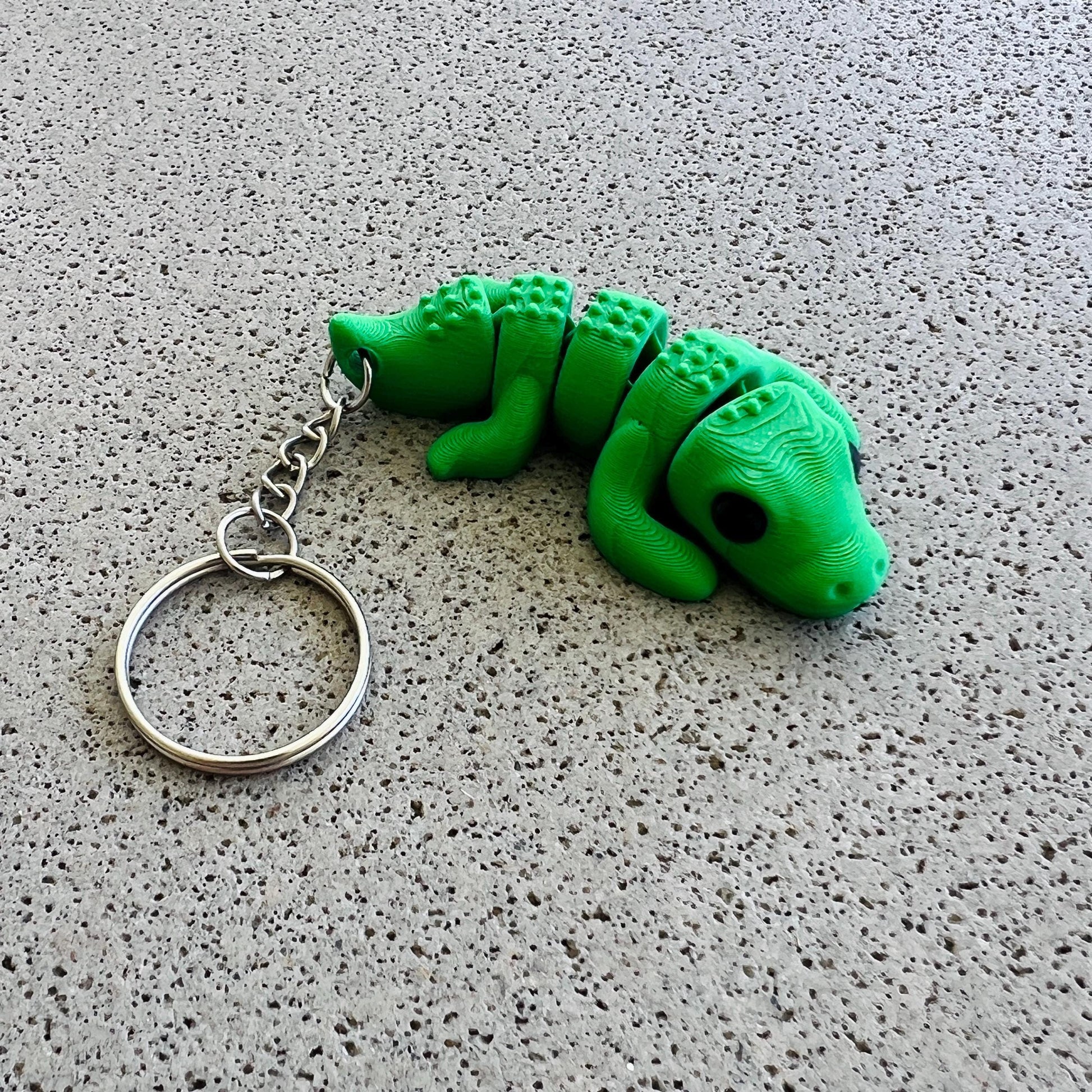 Bright green crocodile-shaped keychain with detailed features, perfect for adding flair to keys or bags.