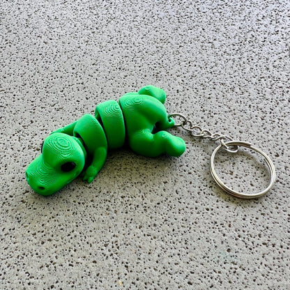Vibrant green T-Rex keychain with detailed texture, perfect for adding a fun prehistoric touch to your accessories.