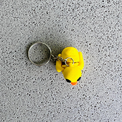 Bright yellow duck keychain with playful features, perfect for adding fun to your keys or bags.