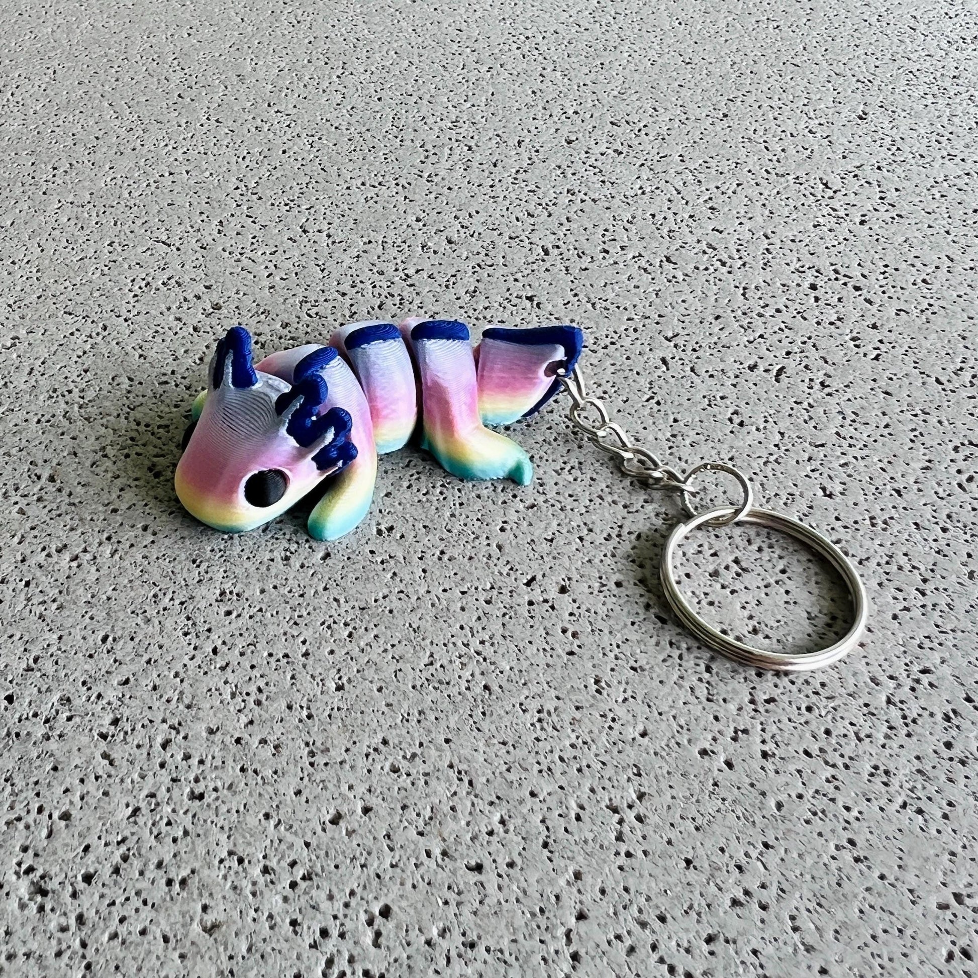 Vibrant rainbow axolotl keychain with colorful body and playful features, perfect for adding flair to bags or keys.