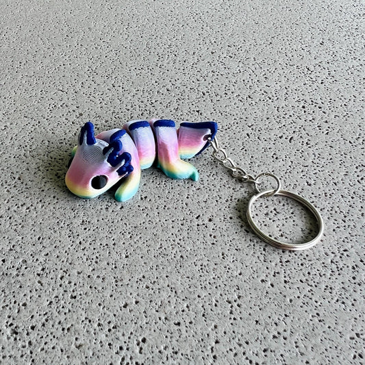 Vibrant rainbow axolotl keychain with colorful body and playful features, perfect for adding flair to bags or keys.