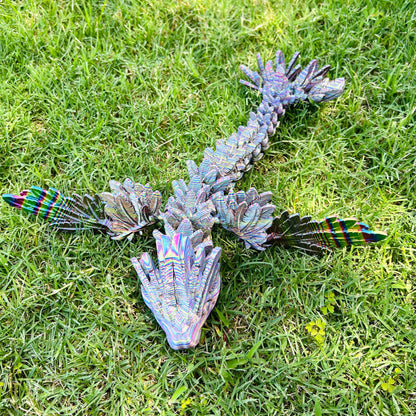 Sleek, iridescent serpent-winged dragon sprawled on vibrant green grass, showcasing intricate details and dynamic design.