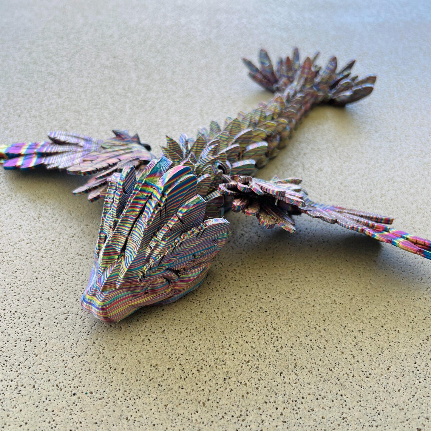 Colorful, winged serpent dragon with intricate scales and wings, poised on a textured surface, exuding a mystical aura.