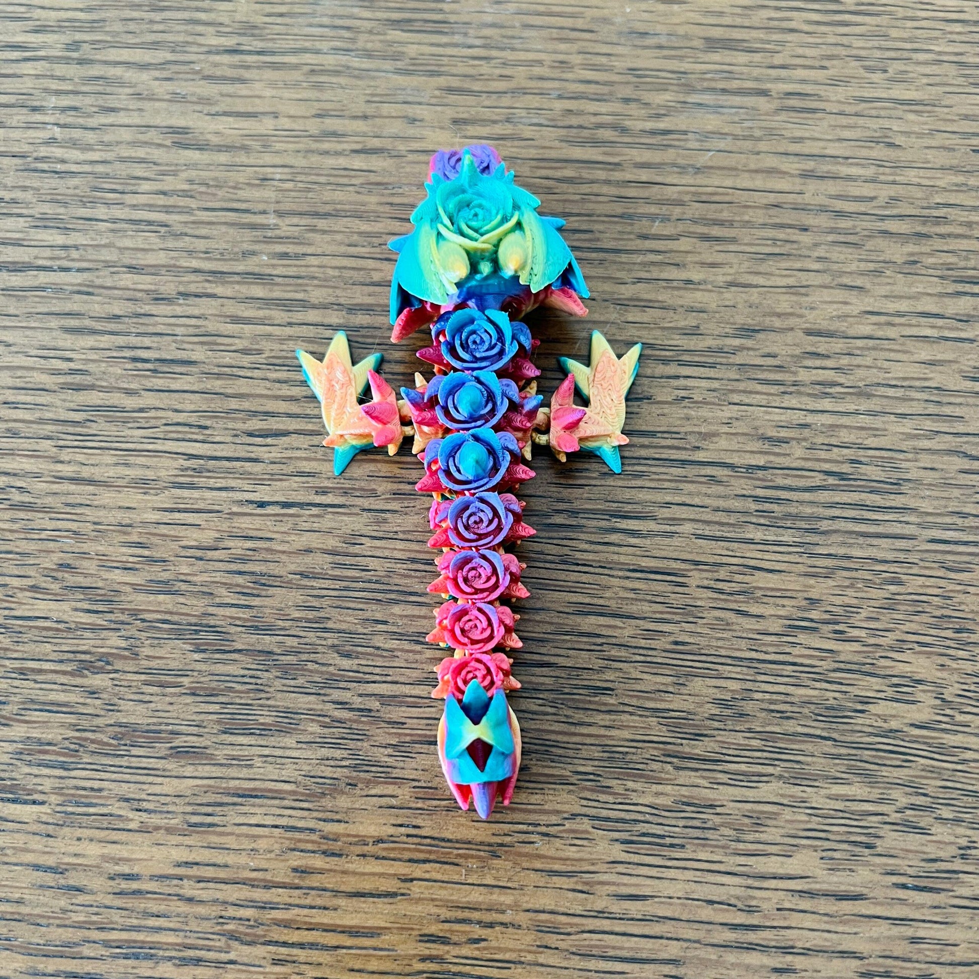 Colorful 3D printed Rose Dragon with intricate floral details and vibrant hues, perfect for sensory play or as a collectible.