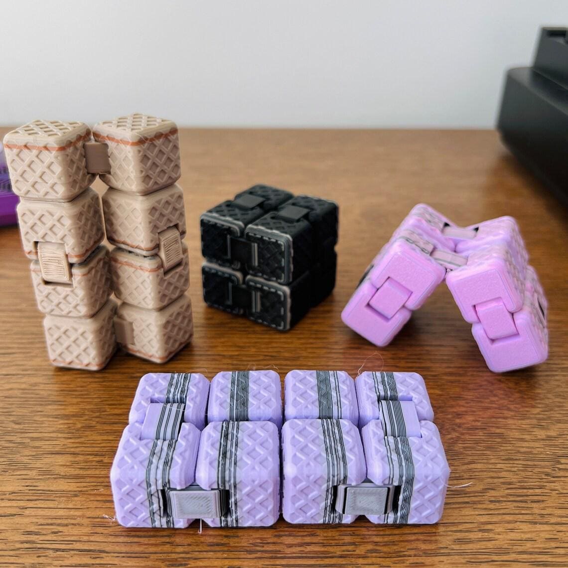 A colorful assortment of six 3D-printed fidgets in various shapes, crafted for tactile engagement and stress relief.