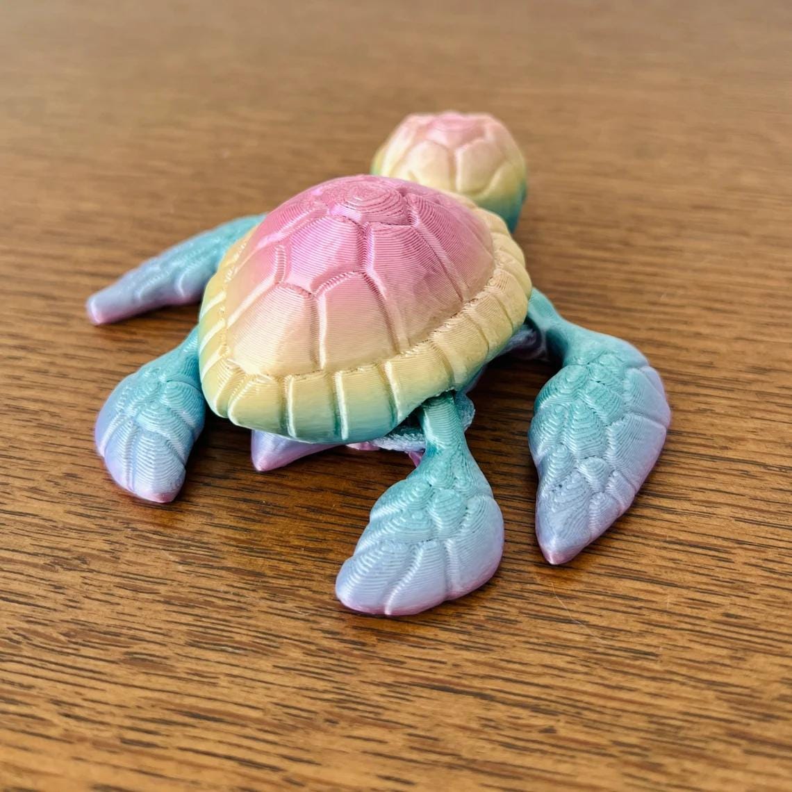 Colorful 3D-printed sea turtle figurine with a gradient shell, showcasing intricate details and ocean-inspired charm.
