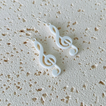 Elegant white treble clef dangle earrings crafted from 925 sterling silver and biobased plastic, perfect for any occasion.