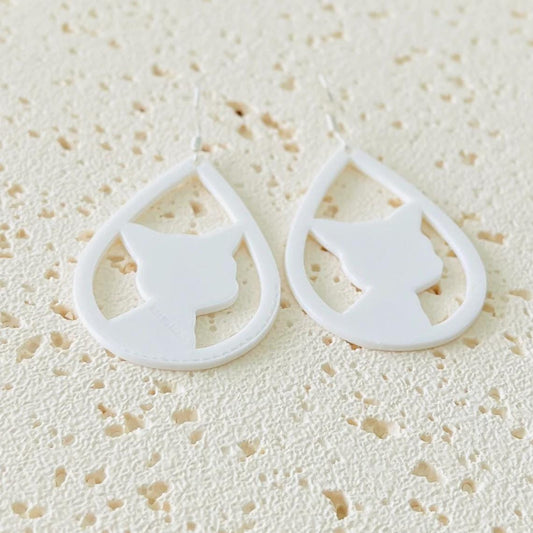 White cat face dangle earrings hang gracefully, crafted from lightweight plastic with elegant sterling silver hooks.