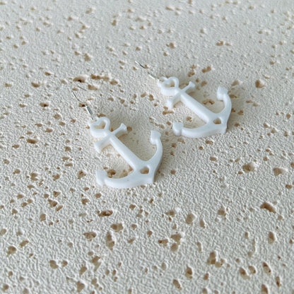 White anchor dangle earrings with sterling silver hooks, adding nautical elegance and movement to any outfit.
