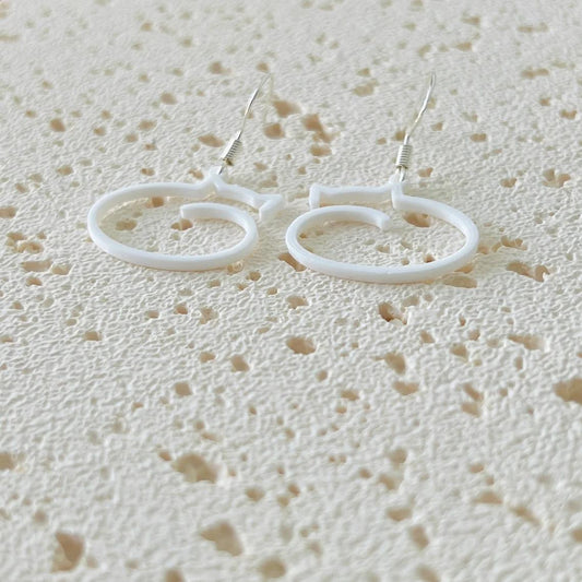 Whimsical cat dangle earrings in white biobased plastic, featuring 925 sterling silver hooks for comfortable wear.