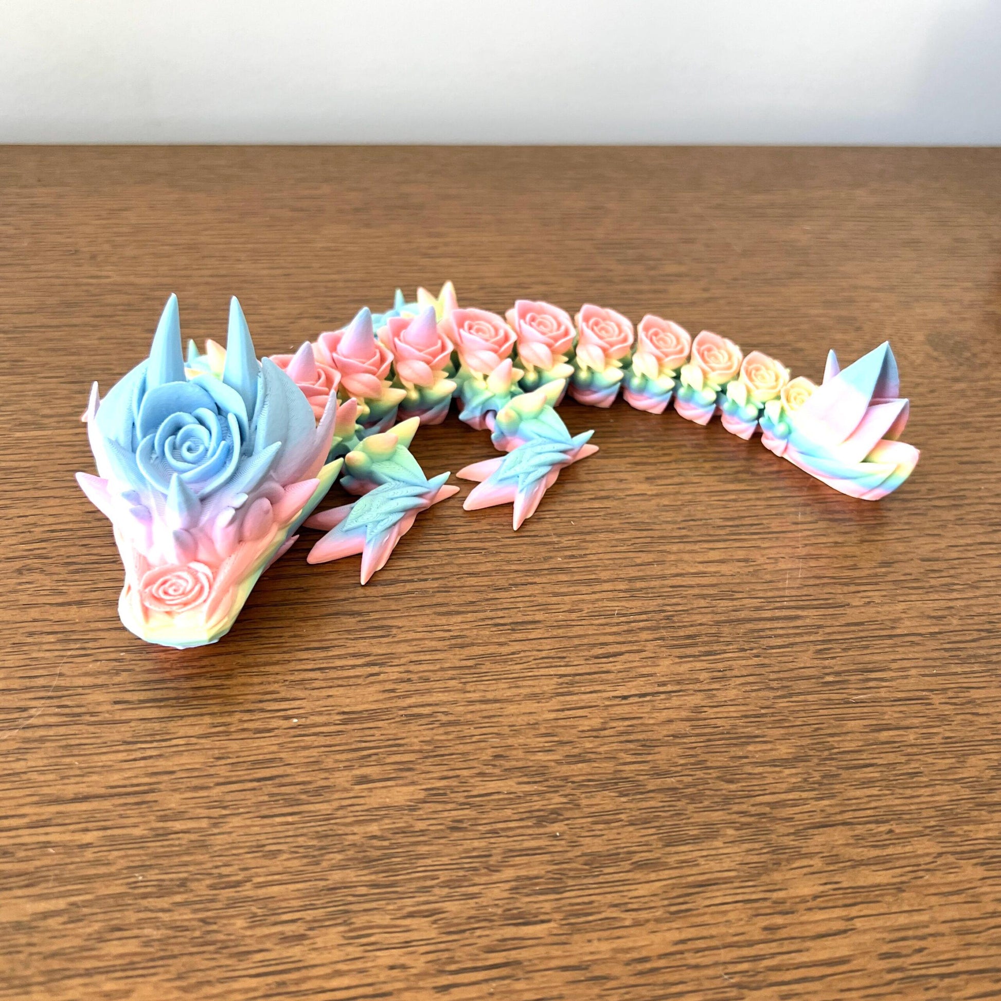 Colorful 3D-printed Baby Rose Dragon with intricate rose details, blending whimsy and charm in a mythical design.
