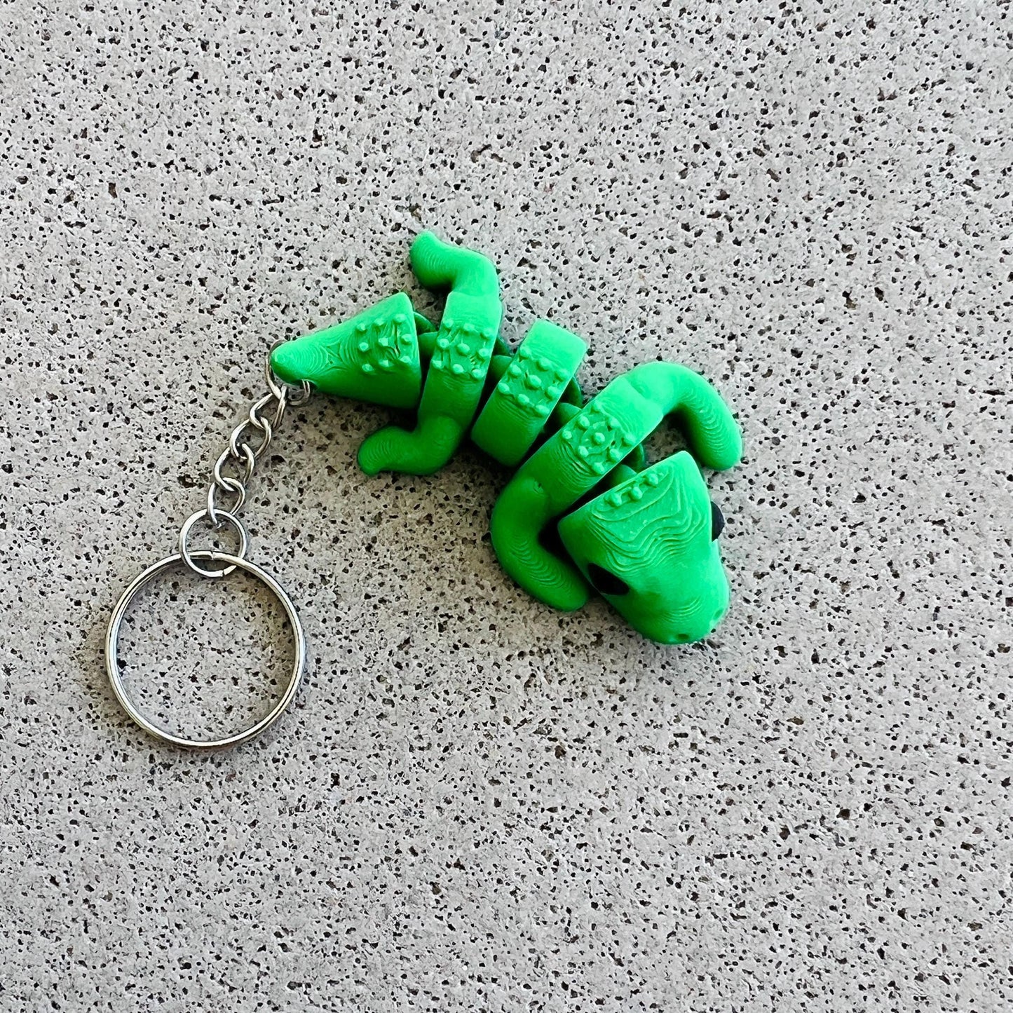 Vibrant green crocodile keychain with detailed scales and a playful design, perfect for adding flair to keys or bags.