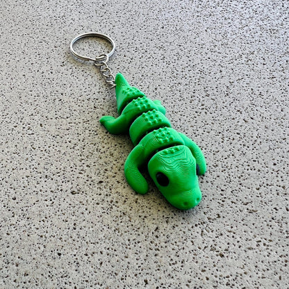 Bright green crocodile-shaped keychain with detailed features, perfect for adding flair to keys or bags.