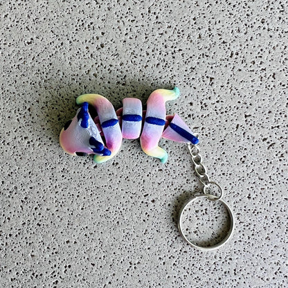Vibrant rainbow axolotl keychain with whimsical colors and playful details, perfect for keys or bags.