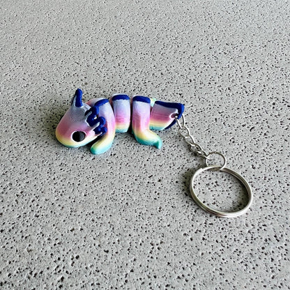 Vibrant rainbow axolotl keychain featuring pastel colors and a playful design, perfect for brightening up your belongings.