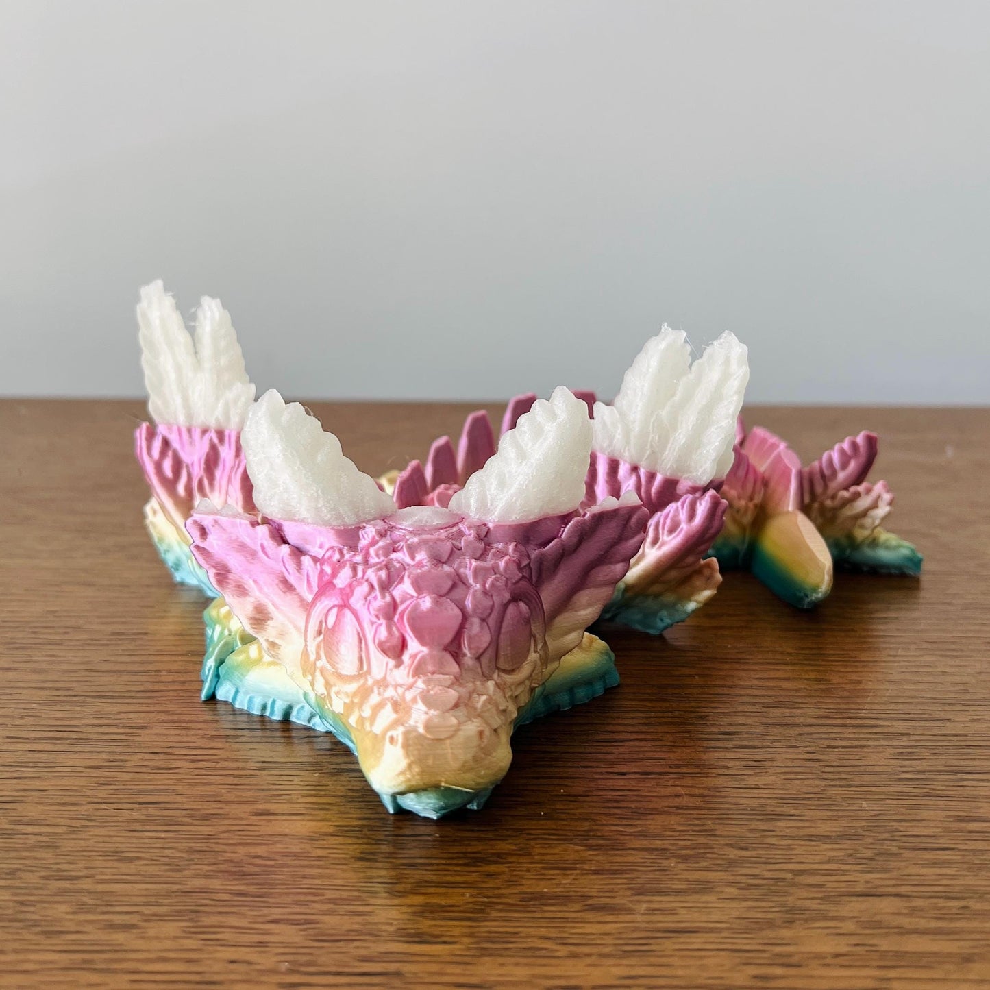 A whimsical dragon with colorful scales and elegant wings, blending axolotl charm with playful details.