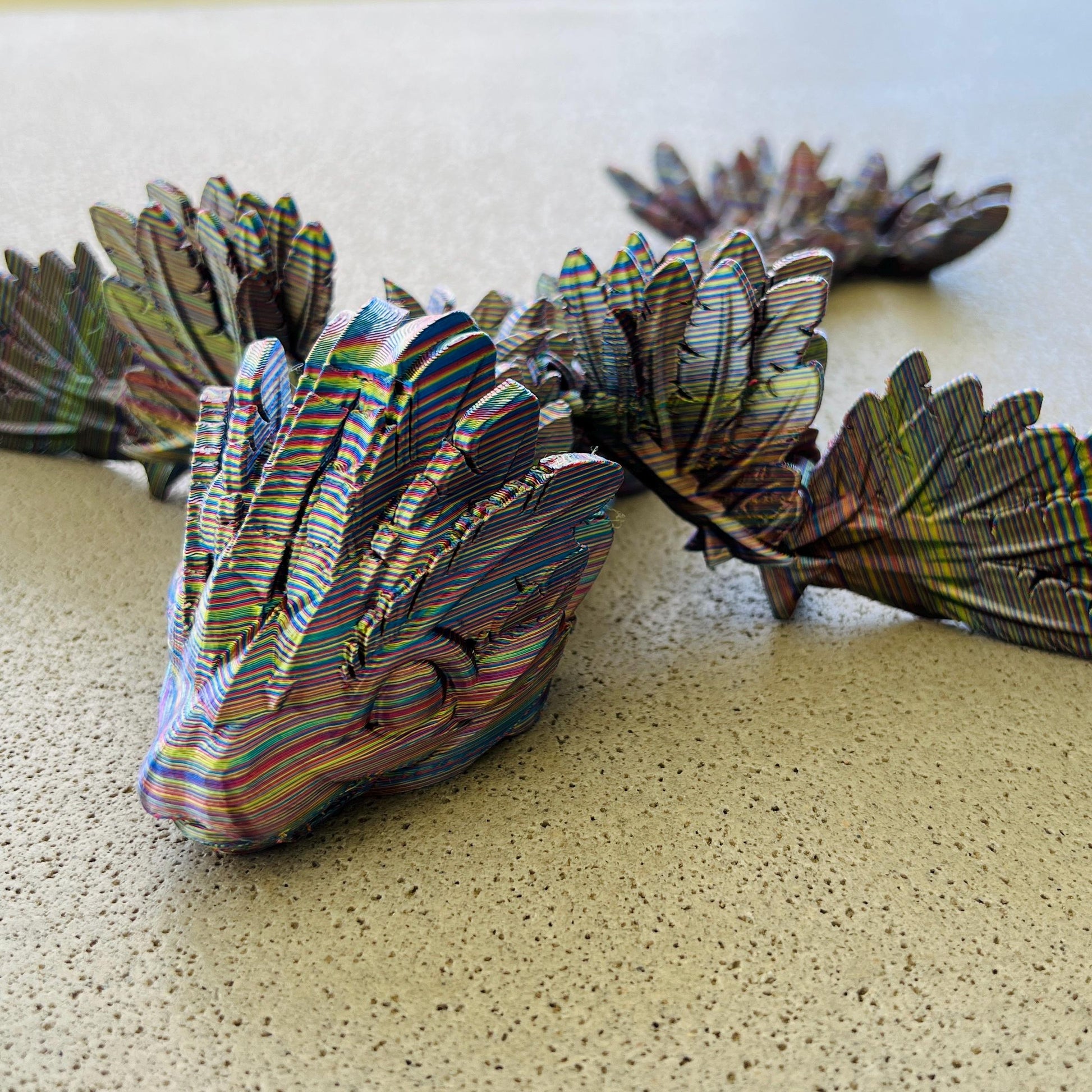 Colorful winged serpent dragon with intricate details, poised elegantly on a textured surface, exuding a sense of flight.