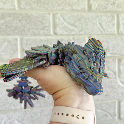 A colorful, intricately detailed winged dragon rests in a hand, showcasing its serpent-like elegance and dynamic form.